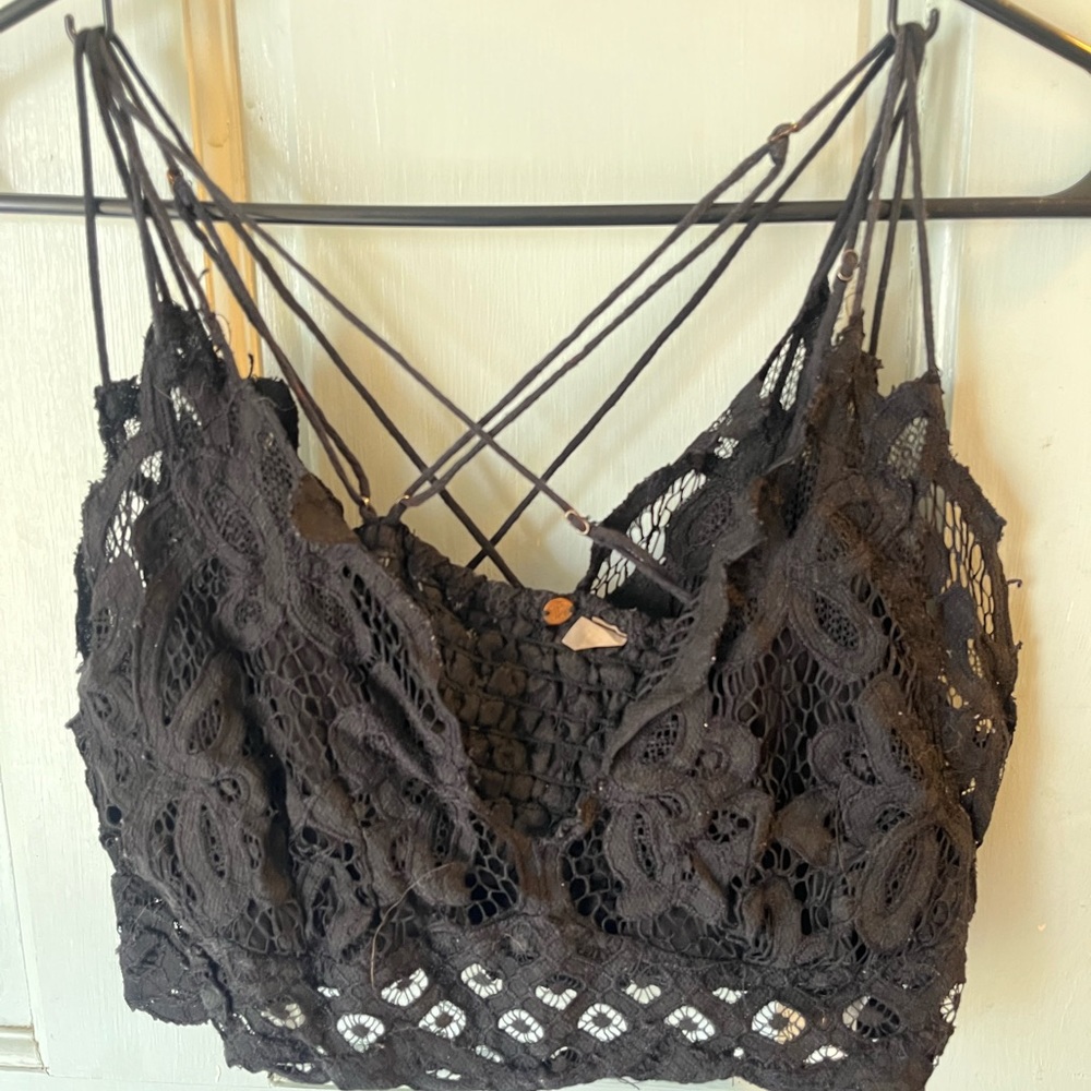 Two identical black bralettes from Free People